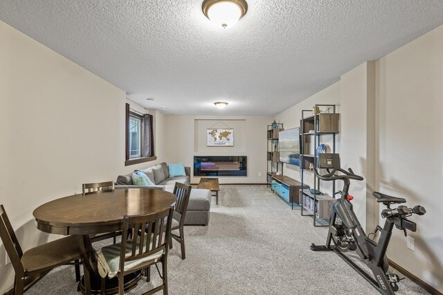 2895 Thunder Bay Ct, Little Canada, MN 55117 - dining space with a textured ceiling, a glass covered fireplace, light colored carpet, and baseboards