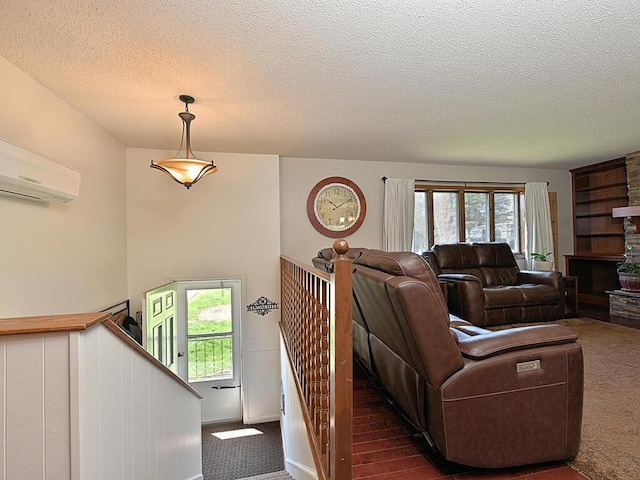 carpeted living room featuring a textured ceiling and an AC wall unit