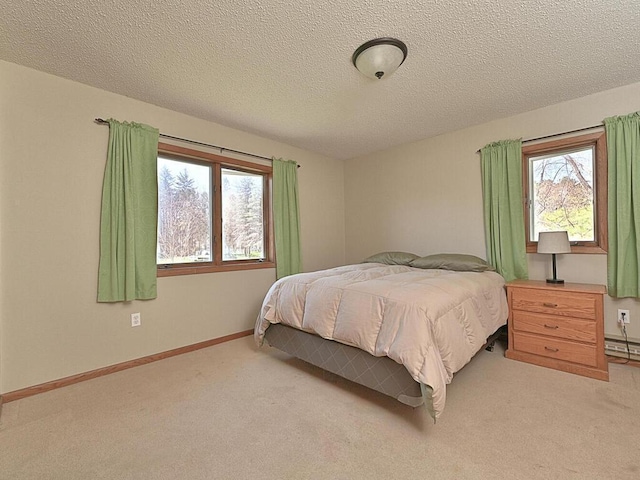 carpeted bedroom featuring a textured ceiling, baseboards, and multiple windows