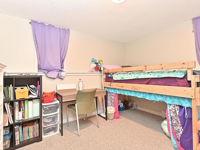 carpeted bedroom featuring baseboards and a textured ceiling