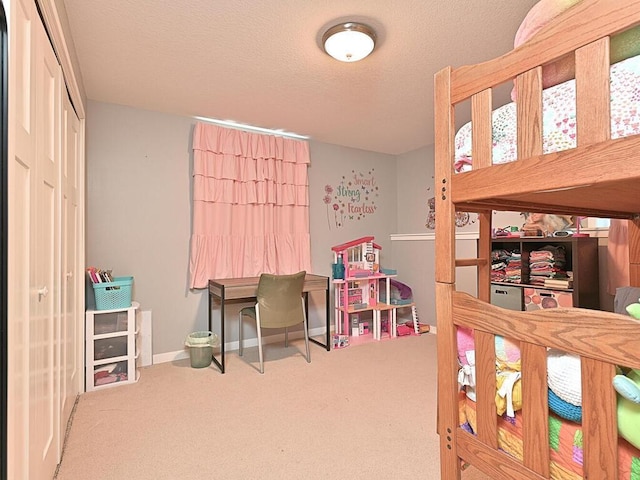 bedroom featuring carpet flooring, a textured ceiling, and baseboards