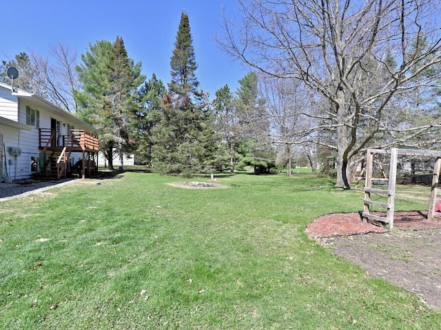 view of yard with stairway and a deck