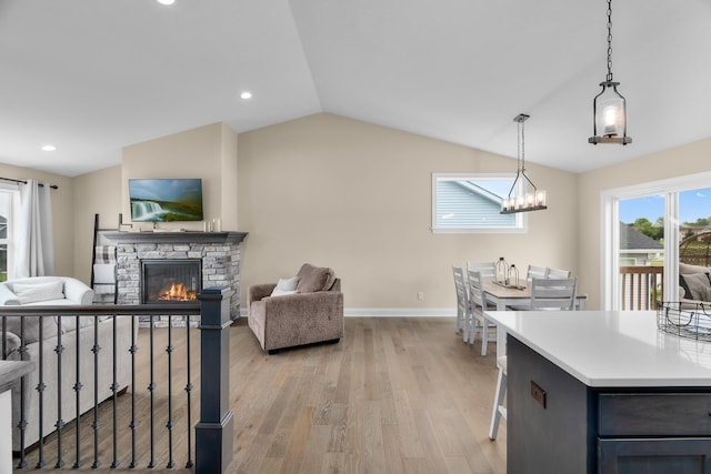 1581 Philipp Way, Shakopee, MN 55379 - living area with light wood-type flooring, a fireplace, lofted ceiling, a chandelier, and recessed lighting