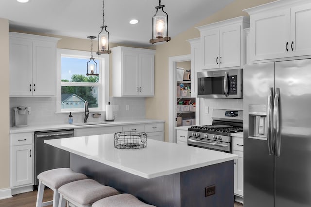 1581 Philipp Way, Shakopee, MN 55379 - kitchen featuring stainless steel appliances, light countertops, recessed lighting, a kitchen breakfast bar, and decorative backsplash