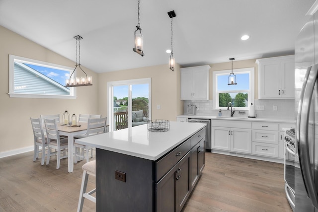 1581 Philipp Way, Shakopee, MN 55379 - kitchen featuring backsplash, healthy amount of natural light, white cabinetry, light wood-style floors, and lofted ceiling