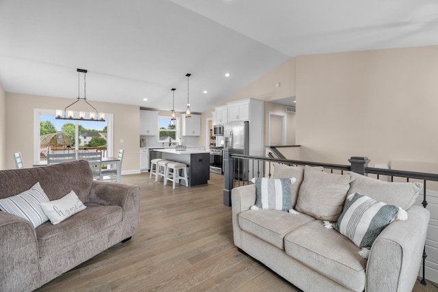 1581 Philipp Way, Shakopee, MN 55379 - living room featuring light wood-type flooring, a chandelier, vaulted ceiling, and recessed lighting