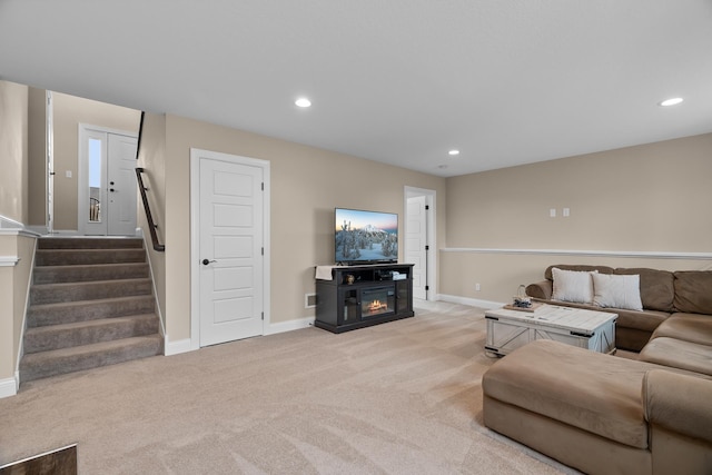 1581 Philipp Way, Shakopee, MN 55379 - living room featuring light colored carpet, stairway, recessed lighting, and a glass covered fireplace