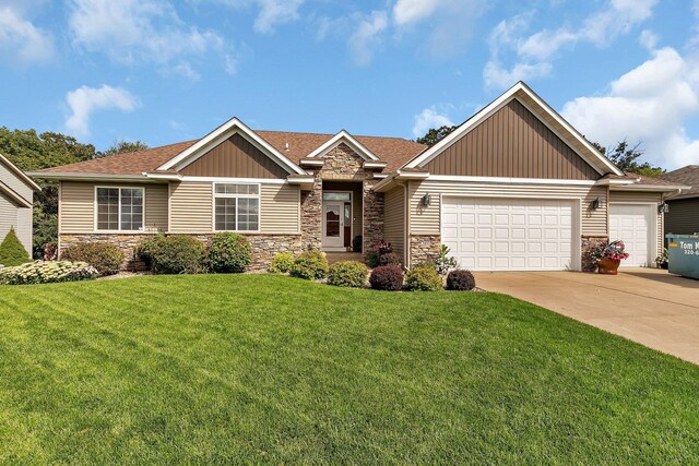 3160 Orchid Dr NE, Sauk Rapids, MN 56379 - view of front of house with an attached garage, a front yard, stone siding, and concrete driveway