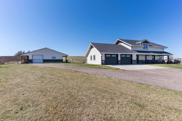 exterior space featuring a front lawn, fence, and driveway