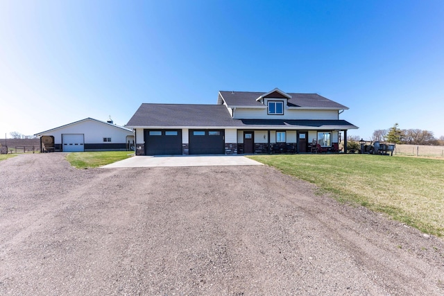 view of front of home with stone siding, driveway, and a front yard