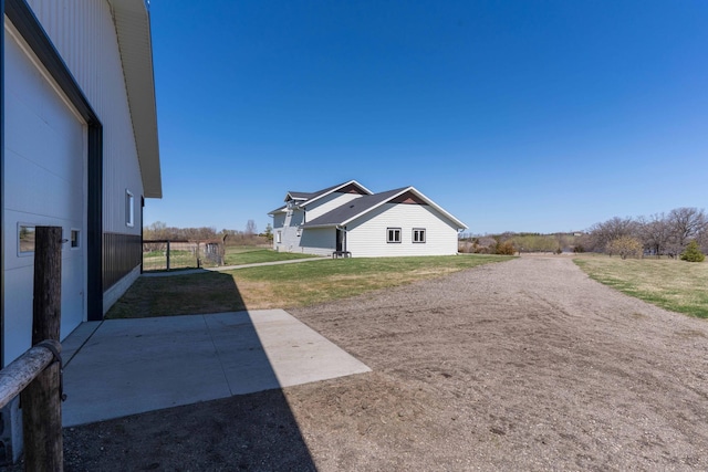 view of side of property with a patio area and a yard