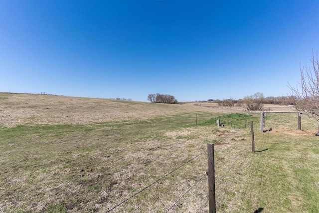 view of yard featuring a rural view and fence