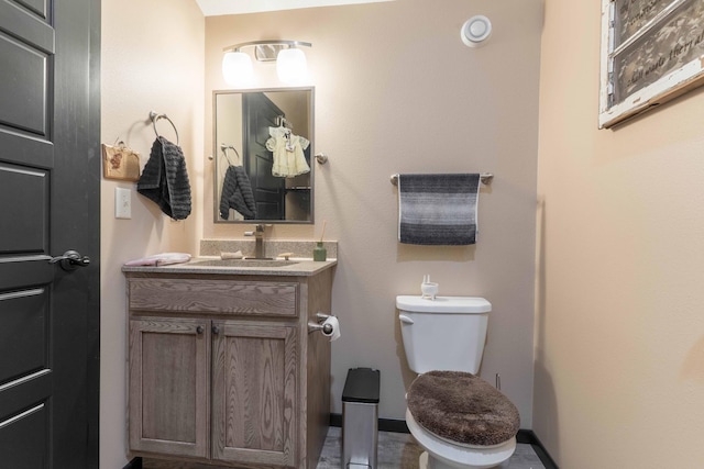 bathroom featuring toilet and vanity