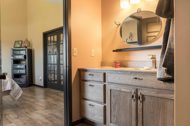 bathroom with vanity and wood finished floors