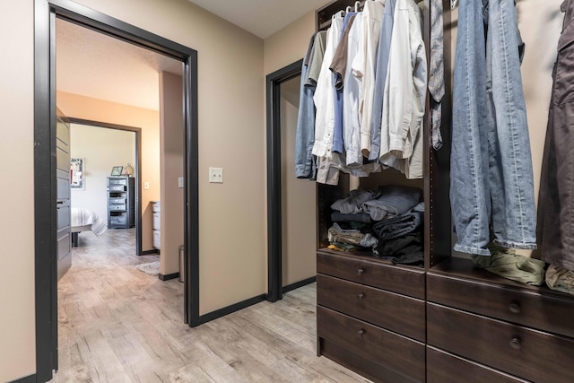 spacious closet featuring light wood-style flooring