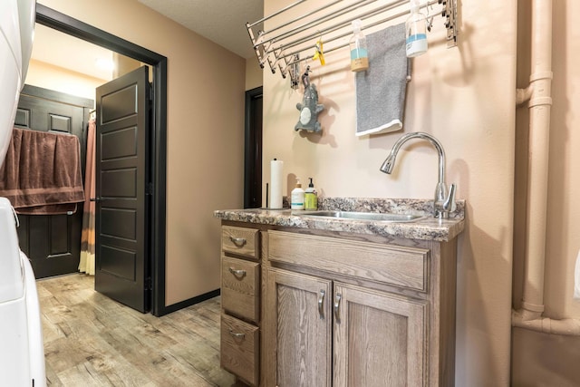 bathroom featuring wood finished floors and vanity