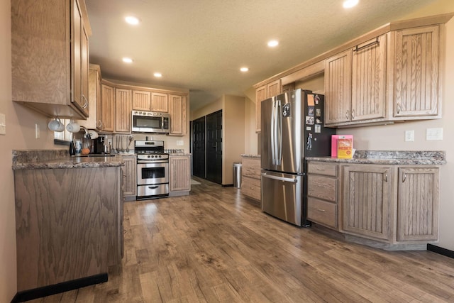 kitchen with light brown cabinetry, dark wood-style flooring, stainless steel appliances, and recessed lighting