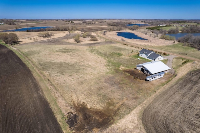 birds eye view of property with a water view and a rural view