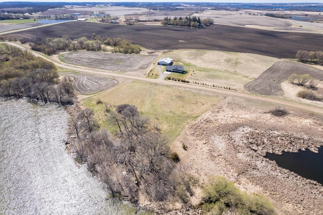 birds eye view of property featuring a water view and a rural view