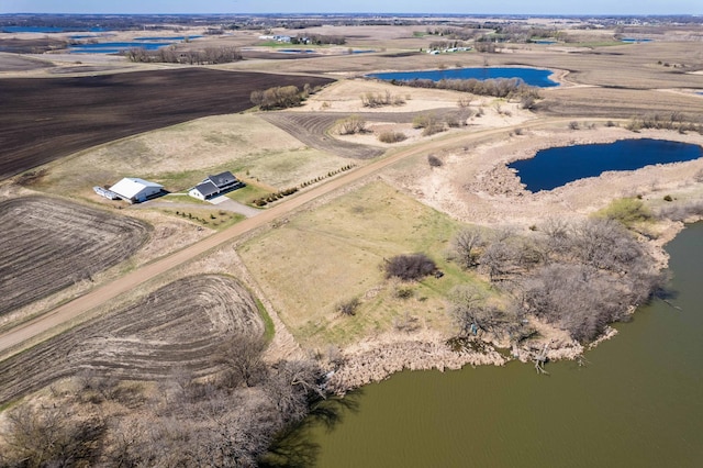 birds eye view of property with a water view and a rural view