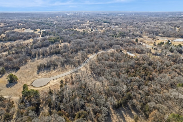 aerial overview of property's location with a heavily wooded area