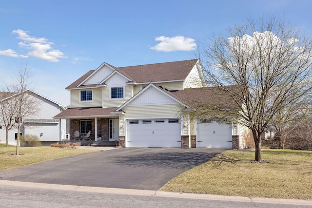craftsman inspired home featuring covered porch, an attached garage, brick siding, and driveway