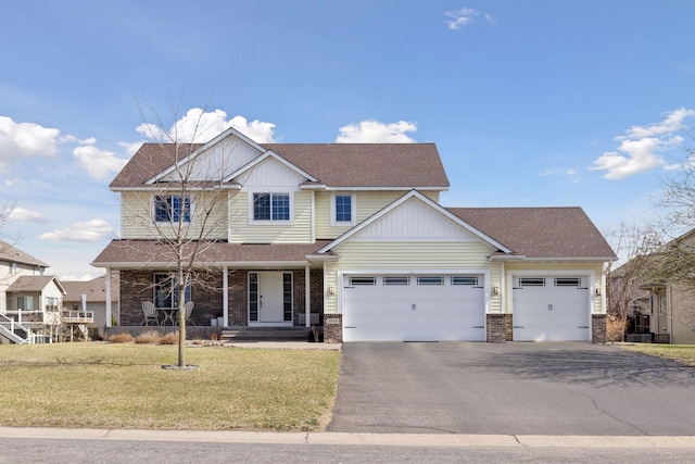 craftsman-style house with an attached garage, brick siding, driveway, and a front lawn