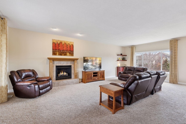 carpeted living area with baseboards and a tiled fireplace