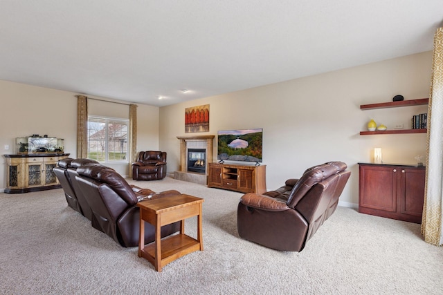 living room with baseboards, light carpet, and a glass covered fireplace