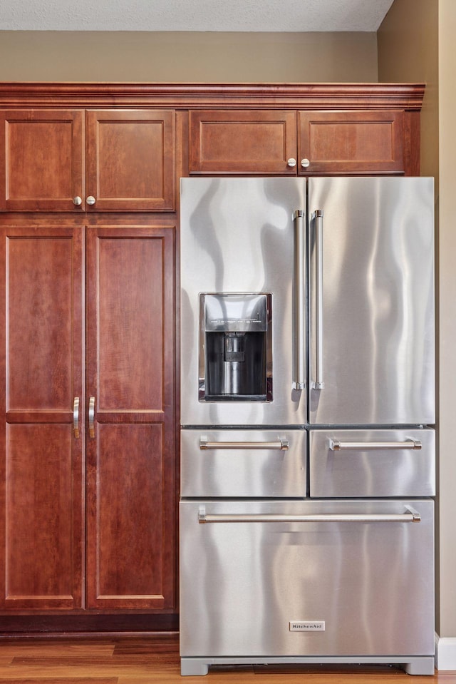 kitchen featuring high end fridge and wood finished floors