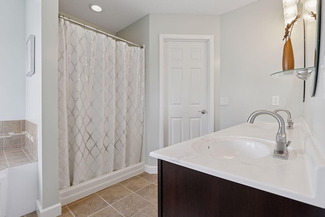 full bathroom with tile patterned floors, curtained shower, and vanity