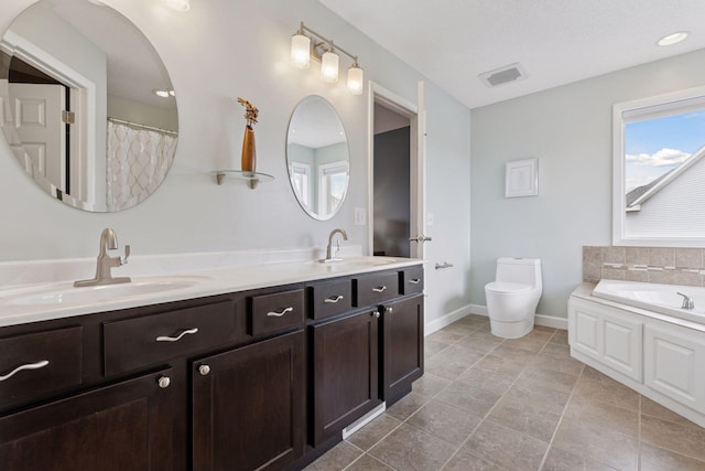 bathroom featuring toilet, visible vents, a sink, and double vanity
