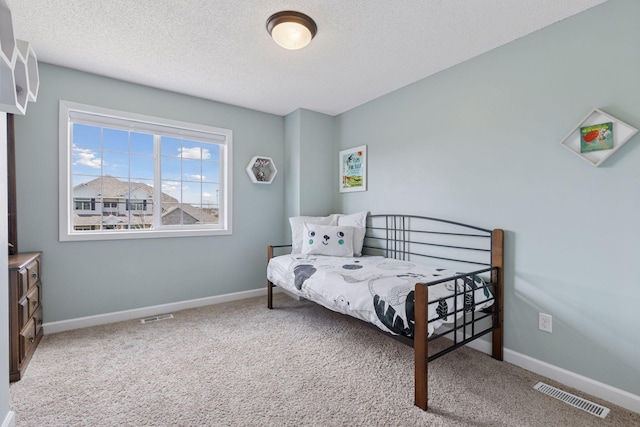bedroom with carpet, a textured ceiling, and visible vents