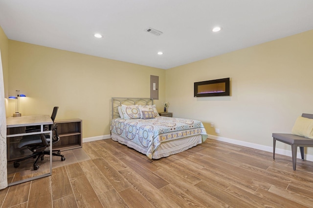 bedroom with recessed lighting, baseboards, visible vents, and wood finished floors