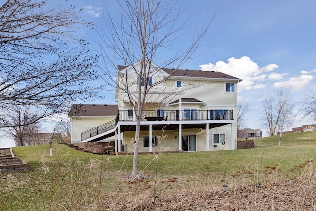 back of house featuring stairway, a wooden deck, and a lawn