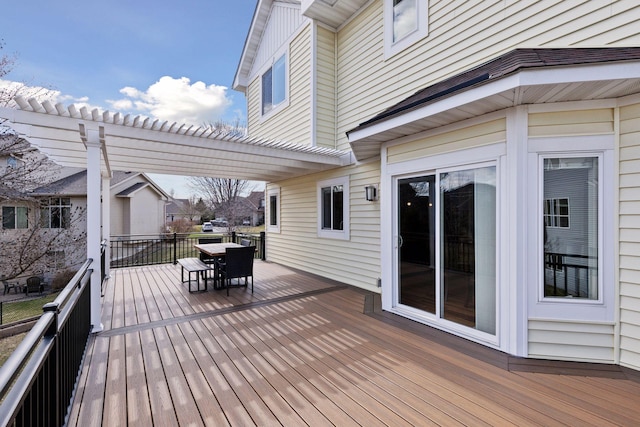wooden deck featuring a pergola and outdoor dining area