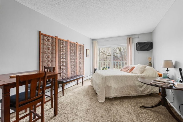 bedroom featuring a textured ceiling and carpet