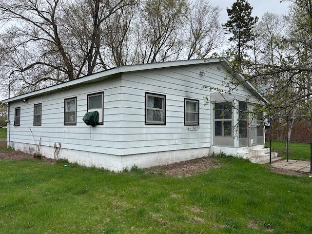 10010 Lake Rd, Watab Twp, MN 56367 - view of side of home featuring a yard and a sunroom