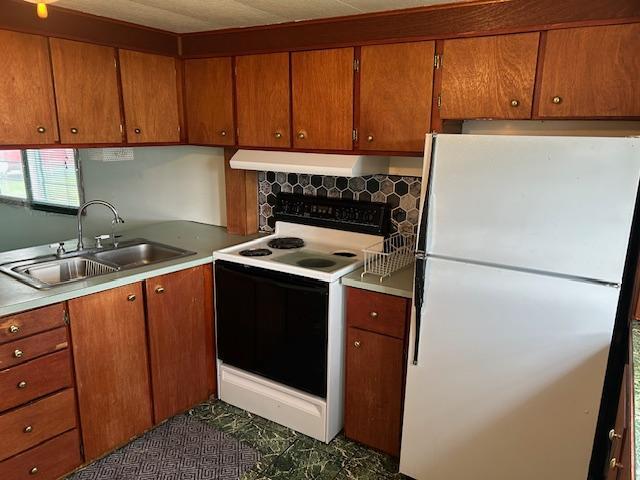 10010 Lake Rd, Watab Twp, MN 56367 - kitchen with a sink, ventilation hood, electric range oven, brown cabinetry, and freestanding refrigerator