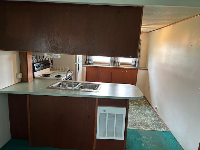 10010 Lake Rd, Watab Twp, MN 56367 - kitchen with visible vents, a peninsula, range with electric stovetop, tile patterned floors, and a sink