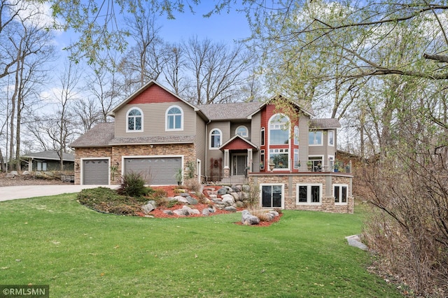 view of front facade featuring a shingled roof, a front lawn, stone siding, a garage, and concrete driveway
