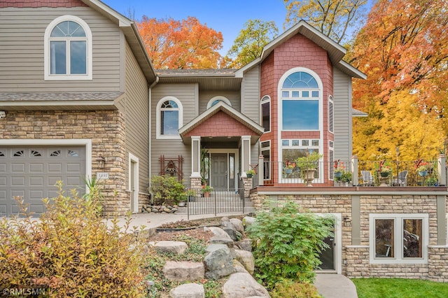 view of front of property with a garage and stone siding
