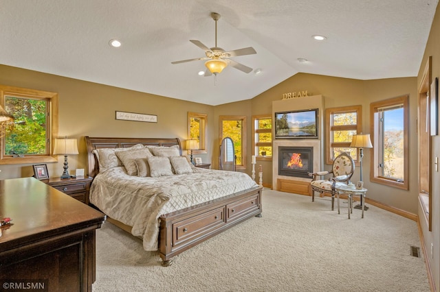 bedroom featuring multiple windows, visible vents, light carpet, and lofted ceiling