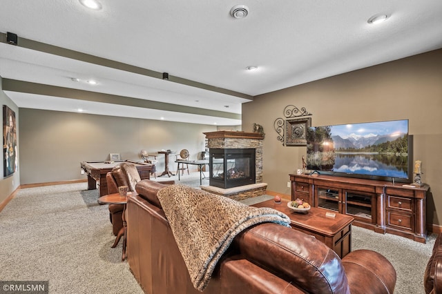 carpeted living area featuring baseboards, a fireplace, and recessed lighting