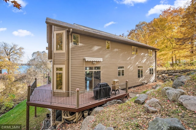 back of house with a deck