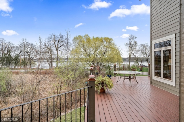 wooden deck featuring a water view