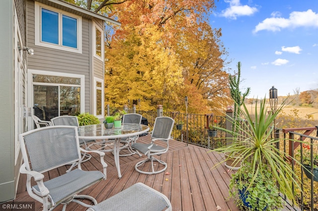 wooden terrace featuring outdoor dining area