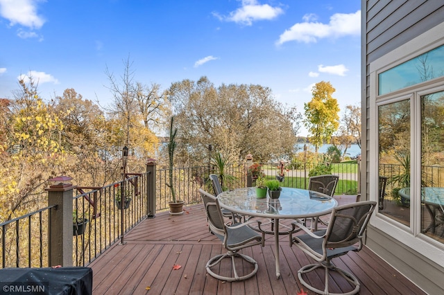 wooden deck featuring outdoor dining area