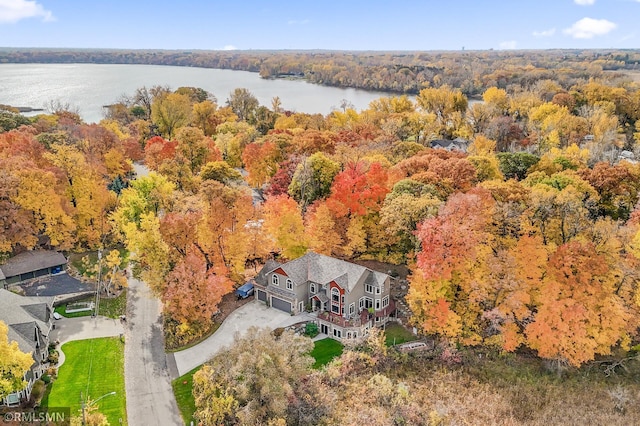 birds eye view of property featuring a water view and a forest view