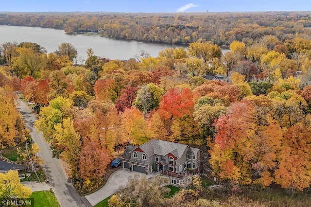 birds eye view of property with a forest view and a water view